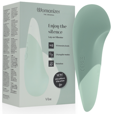 Womanizer Vibe vert sauge devant sa boîte, forme large et pointe arrondie avec panneau clair