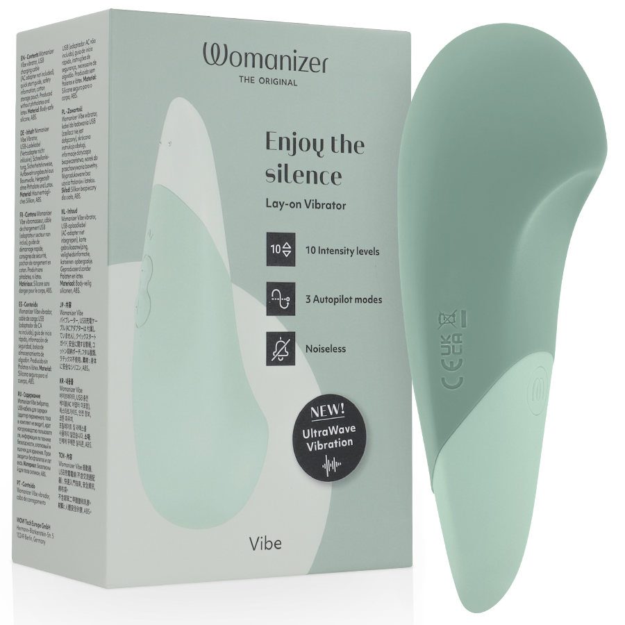 Womanizer Vibe vert sauge devant sa boîte, forme large et pointe arrondie avec panneau clair